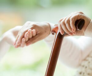 Elder person using walking cane